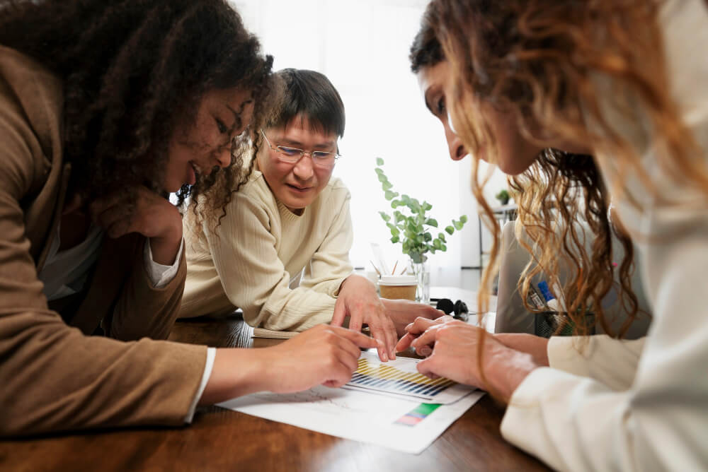 A team reviewing brand guidelines or messaging framework together.