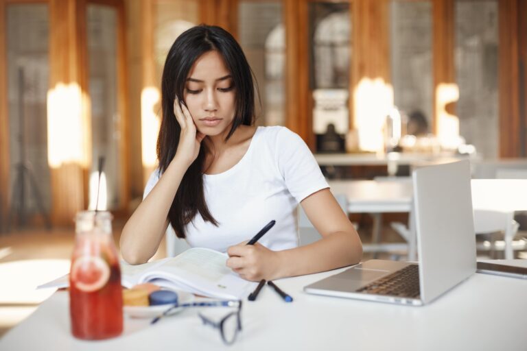 girl in white shirt reading and writing about speech
