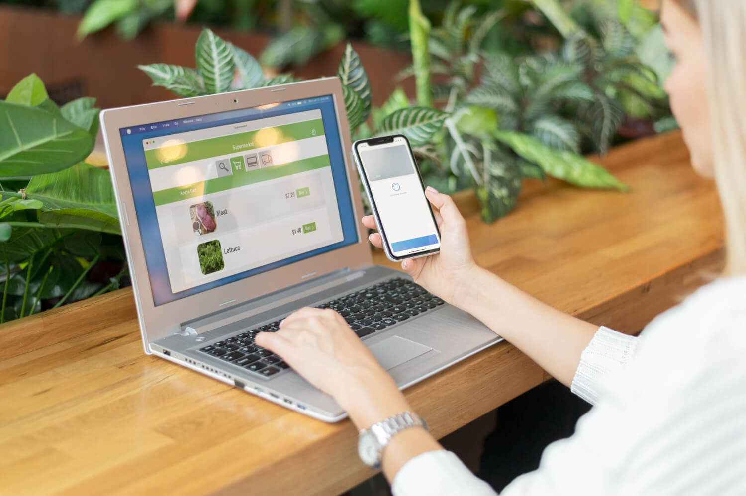 woman looking at mobile and desktop
